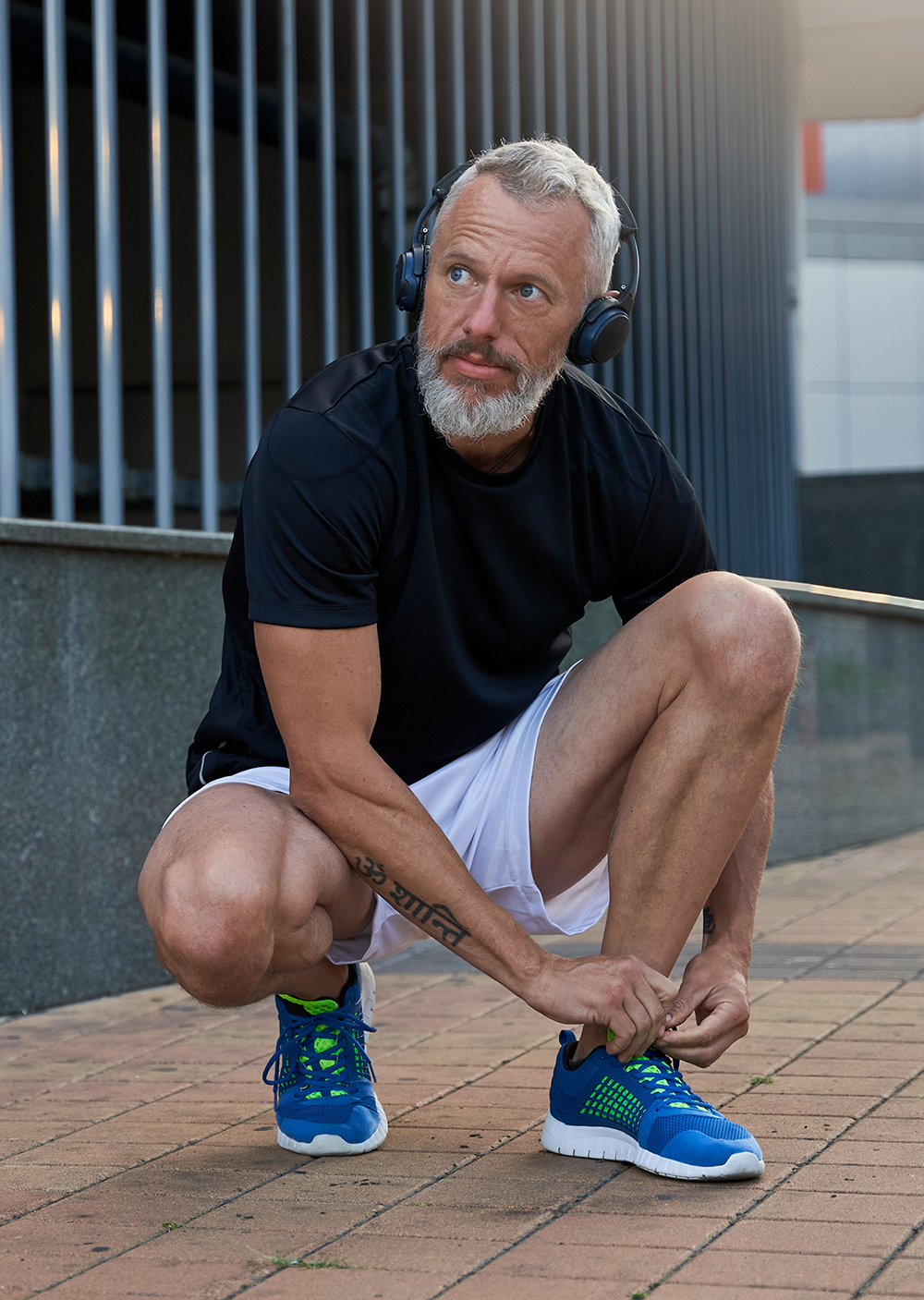 middle aged man getting ready to run