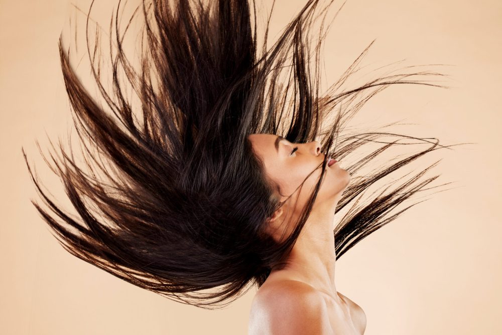 Woman, hair in air and beauty with cosmetics, keratin treatment and shine isolated on studio backgr.